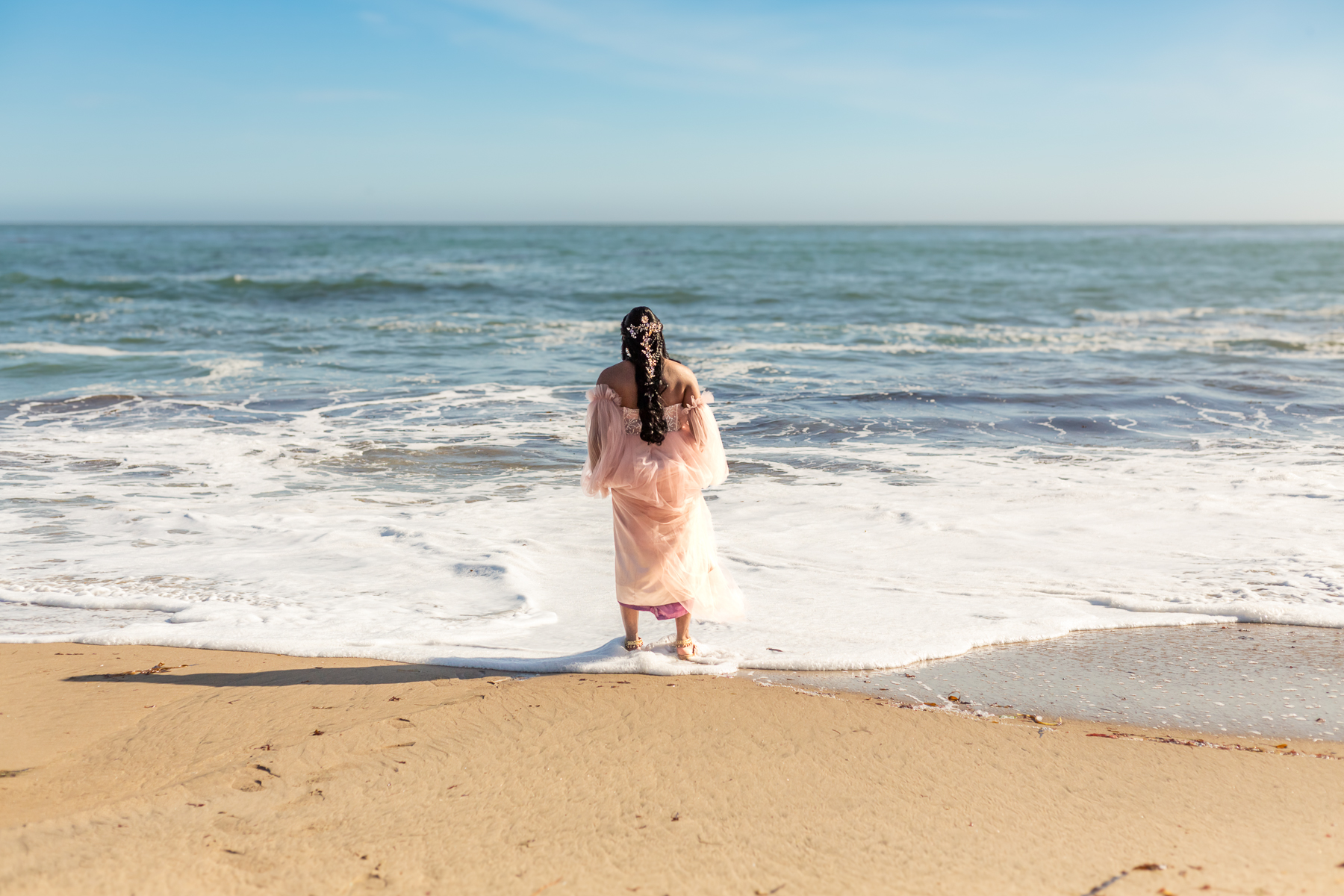 trans woman in pink gown at natural bridges state beach
