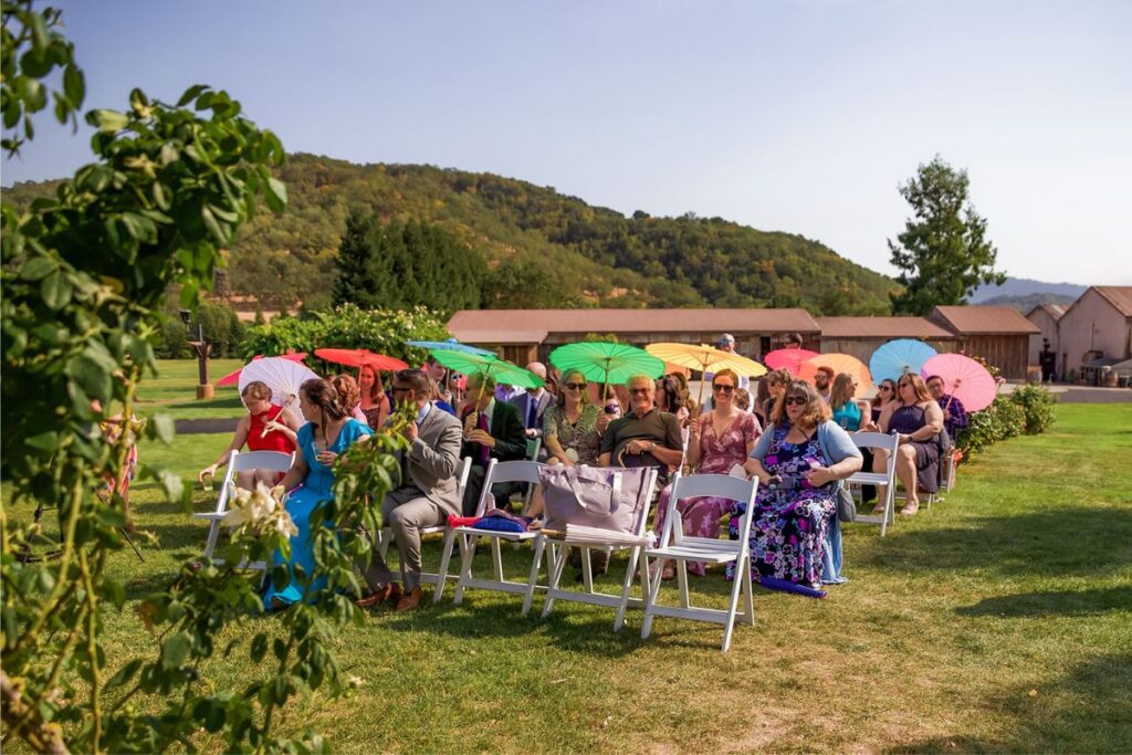 wedding party with their colorful parasols