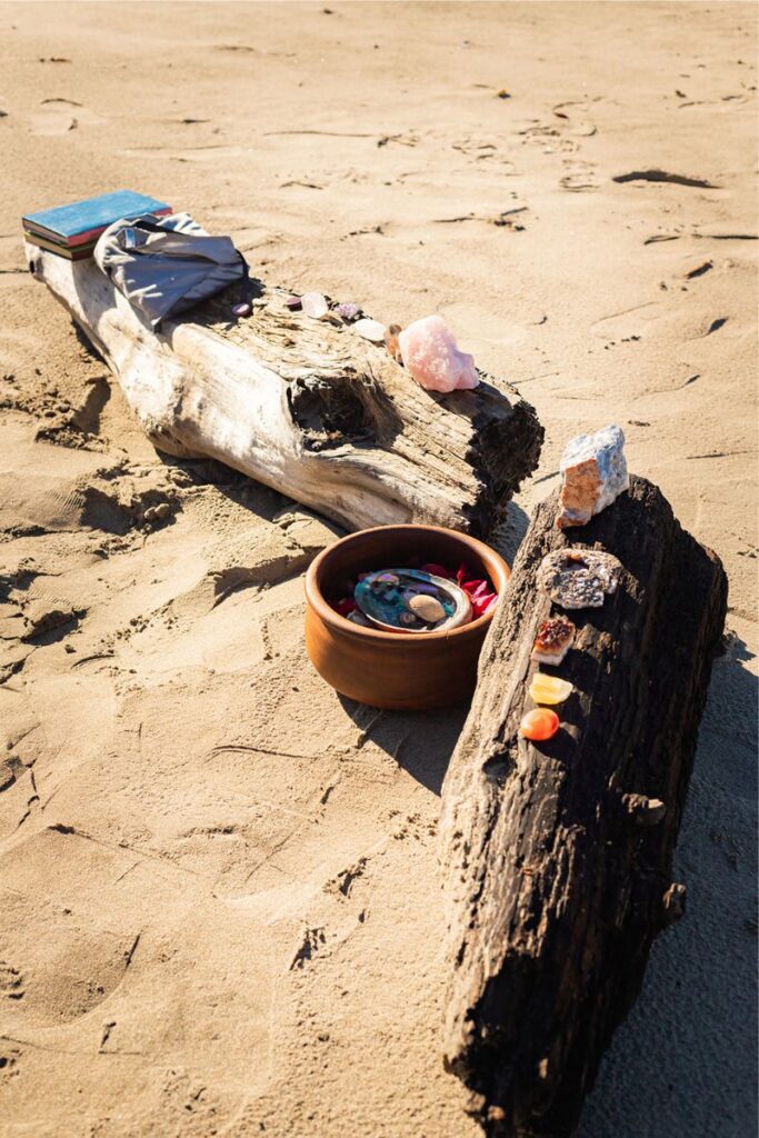 healing crystals being on a piece of wood on the beach