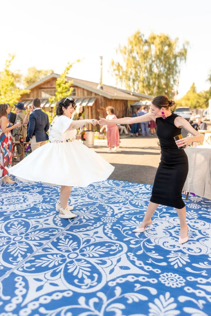 people dancing on a beautiful carpet outdoors as a part of the nontraditional wedding ideas