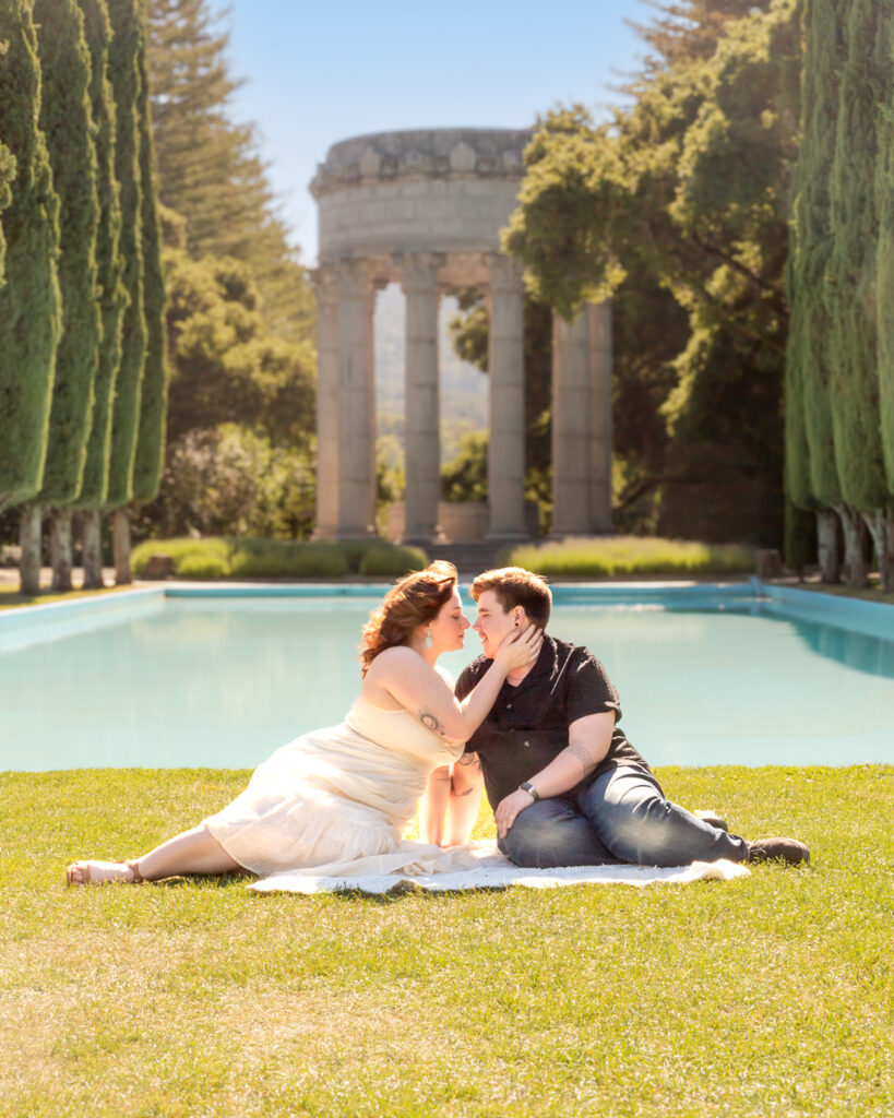 lgbtq couple by a pool in a stunning garden