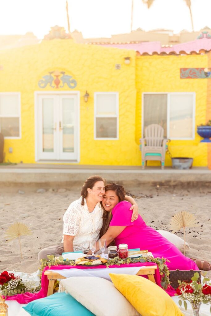 A couple hugging and having a picnic by the beach