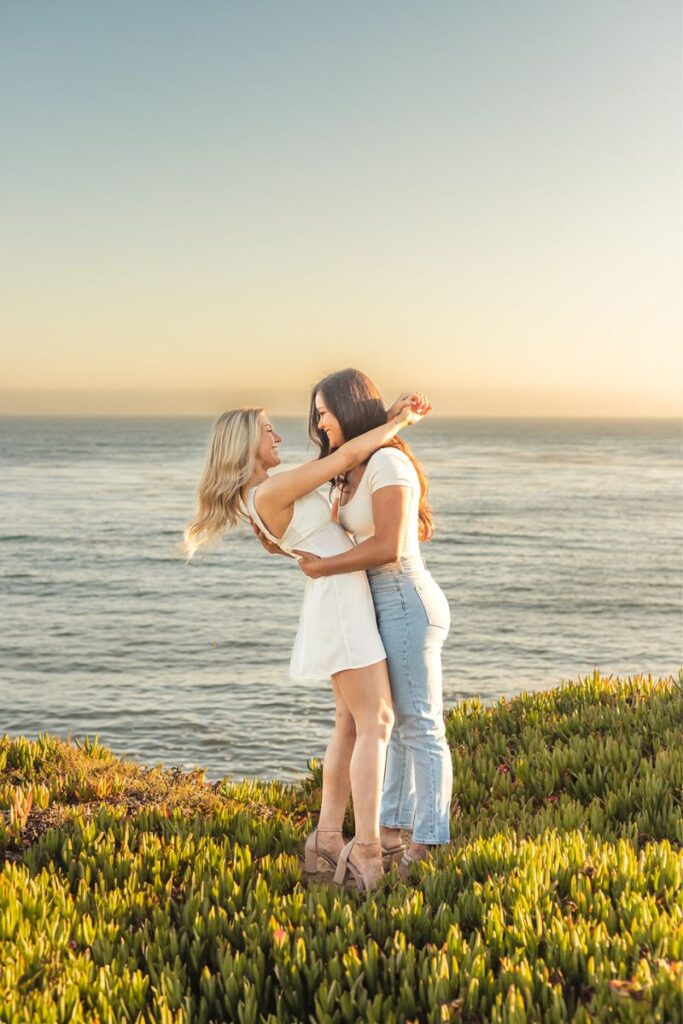 A queer couple hugging and smiling at each other for their Santa Cruz engagement photos