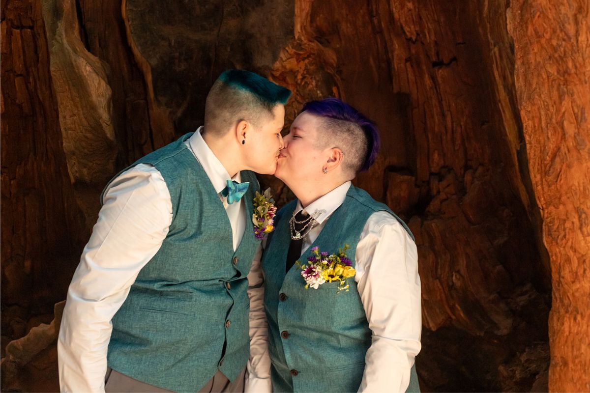 A T4T couple having their neurodivergent wedding and kissing