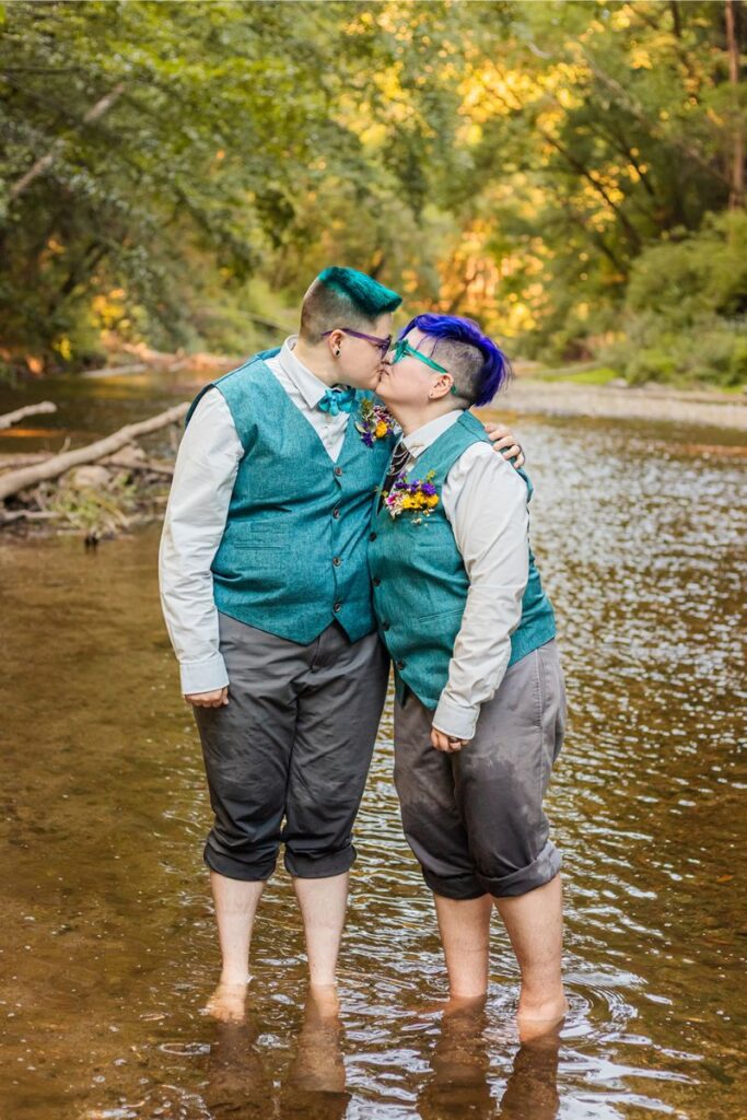 Nova and Arden kissing in a creek