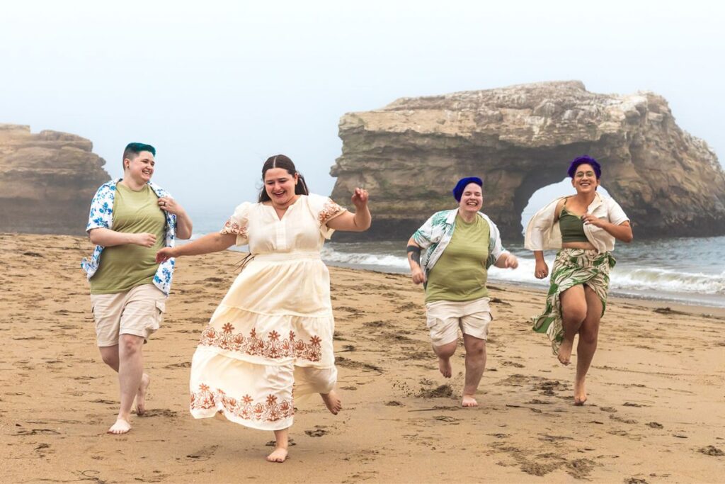 Nova and Arden running and laughing on the beach