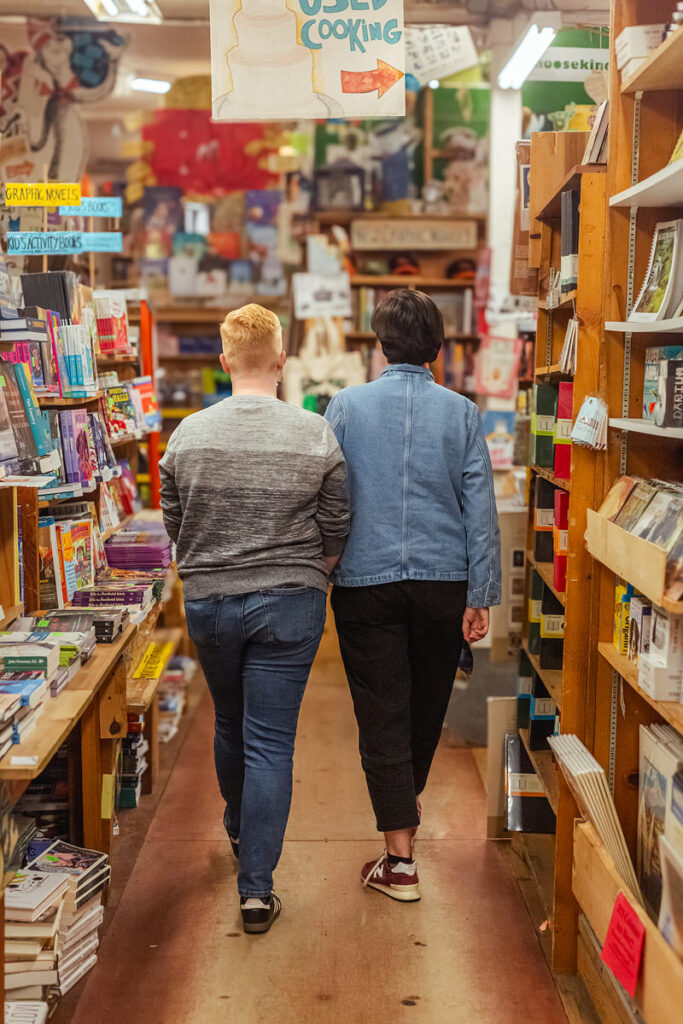 A couple walking together in a bookstore 
