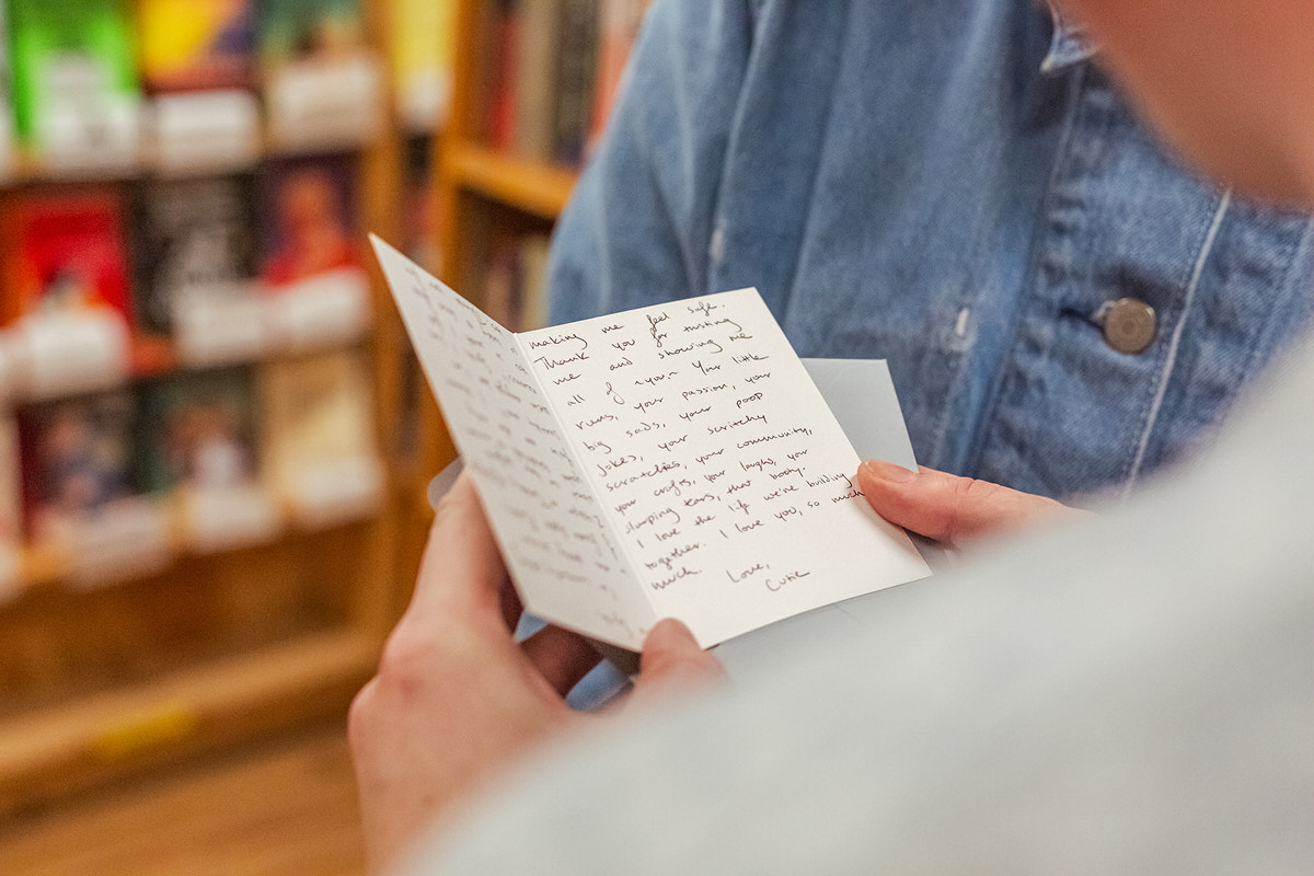 A person reading a hand written note during their San Francisco proposal