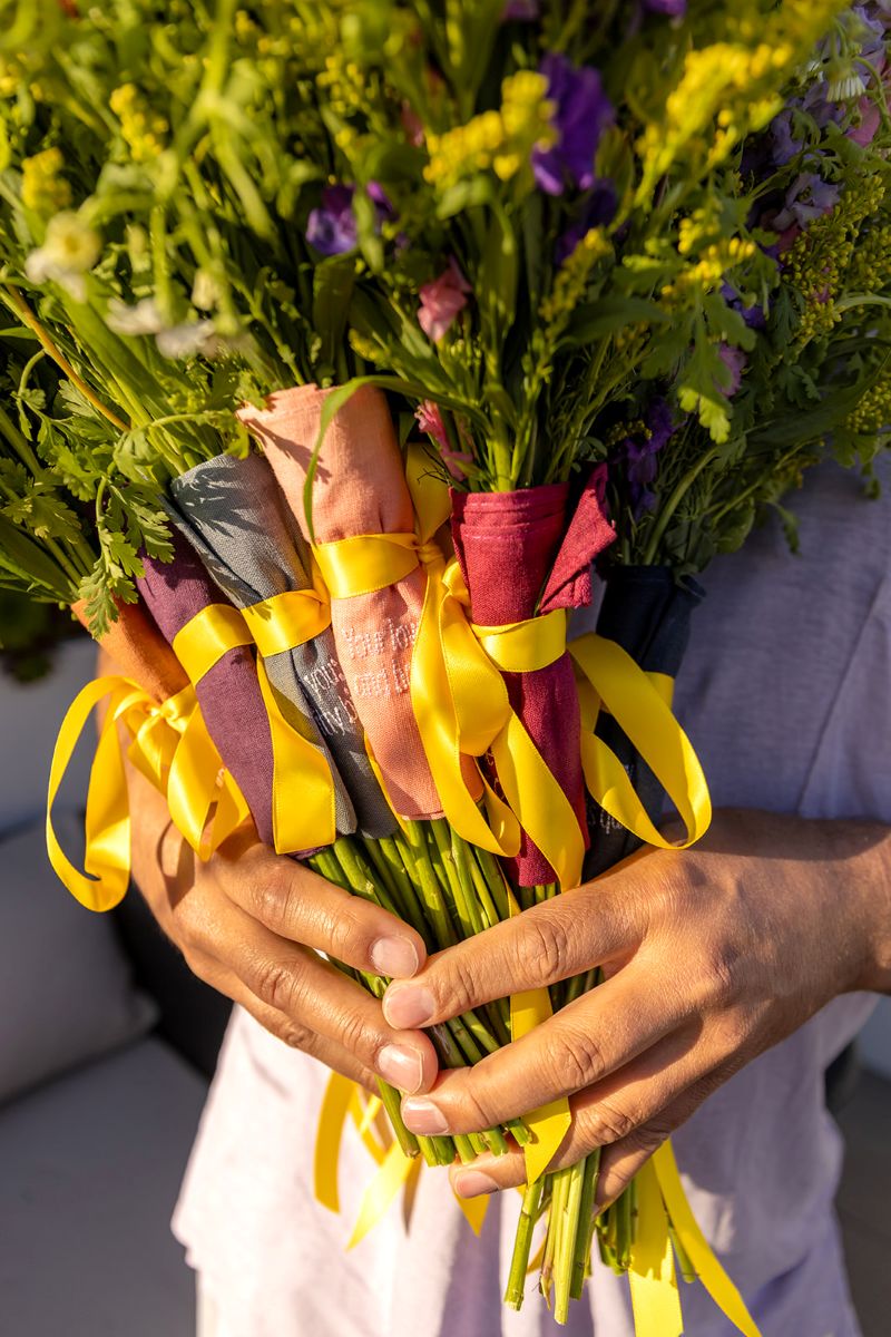 bouquets of different green flowers tied with yellow ribbons