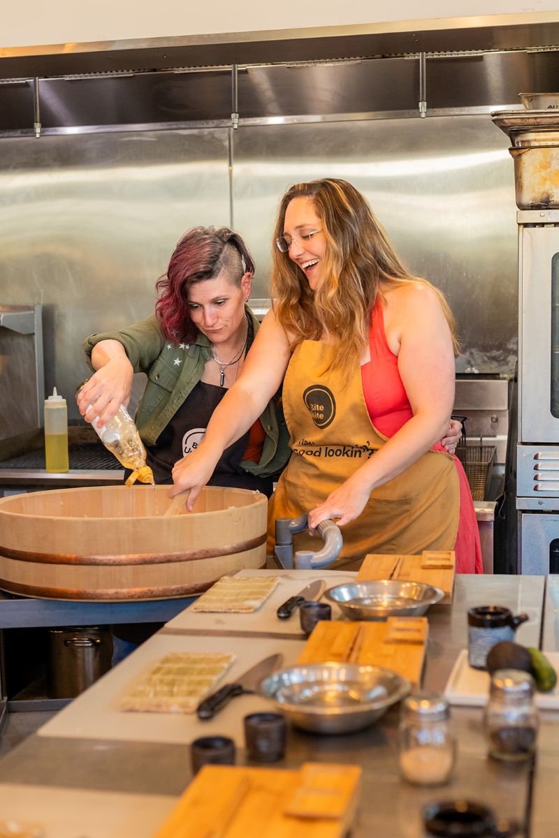 a couple working together during a sushi class at biteunite in san francisco