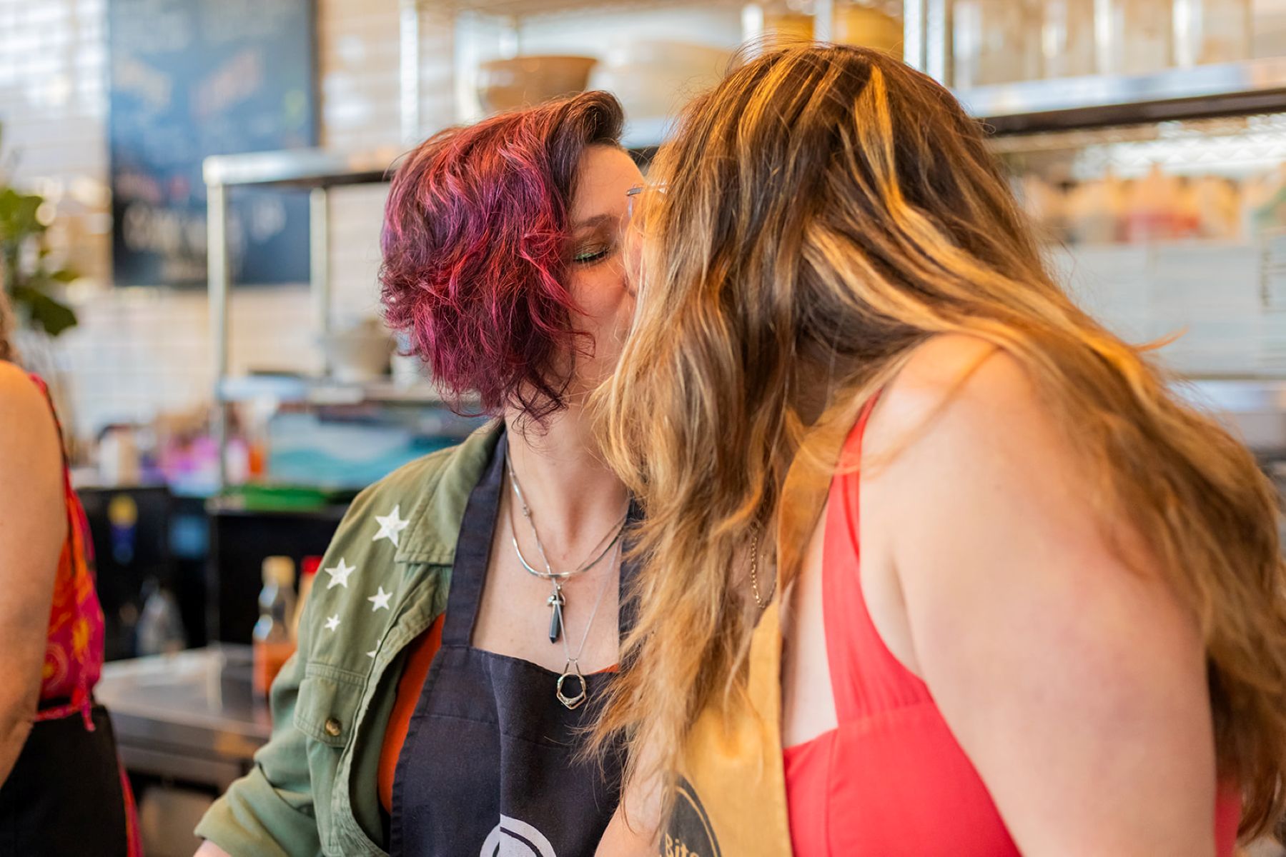 a queer couple kissing during their sushi class at biteunite