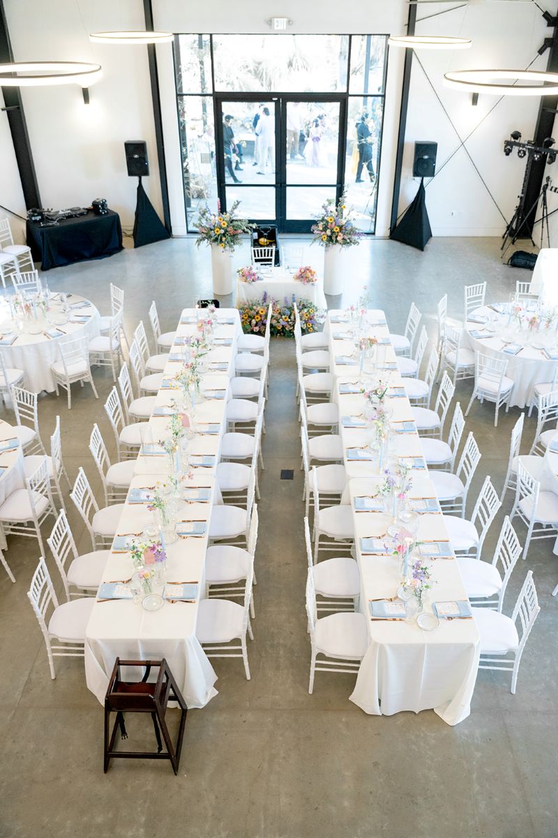 a reception hall decorated with tables and chairs for a wedding reception