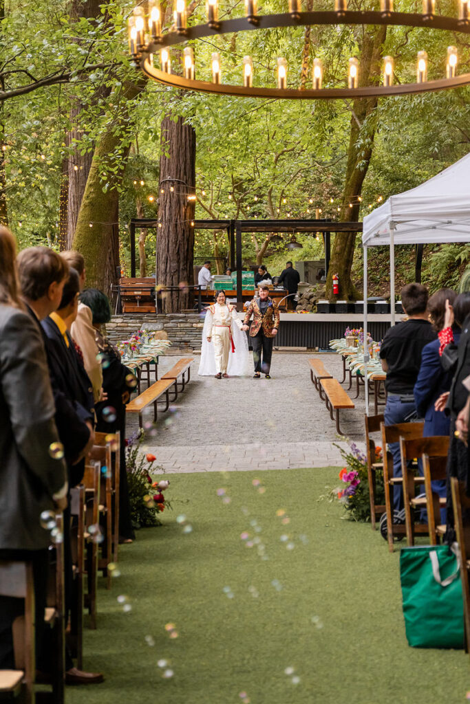 A couple holding hands and walking down the aisle together
