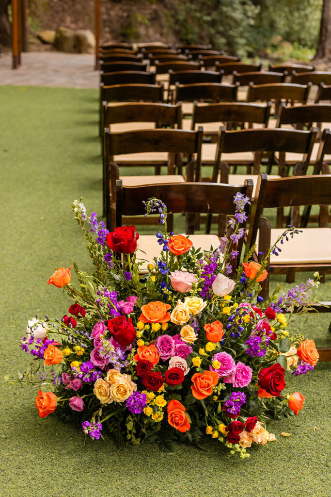 A colorful flower arrangement at the back of a row of chairs