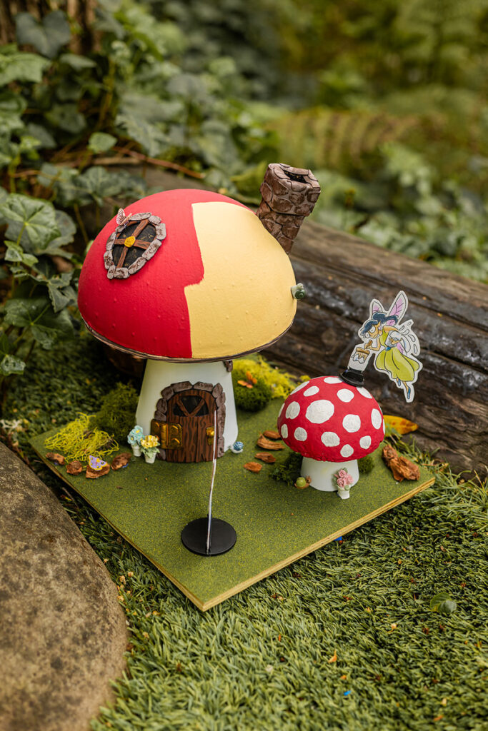 A small diorama of mushroom houses in the woods