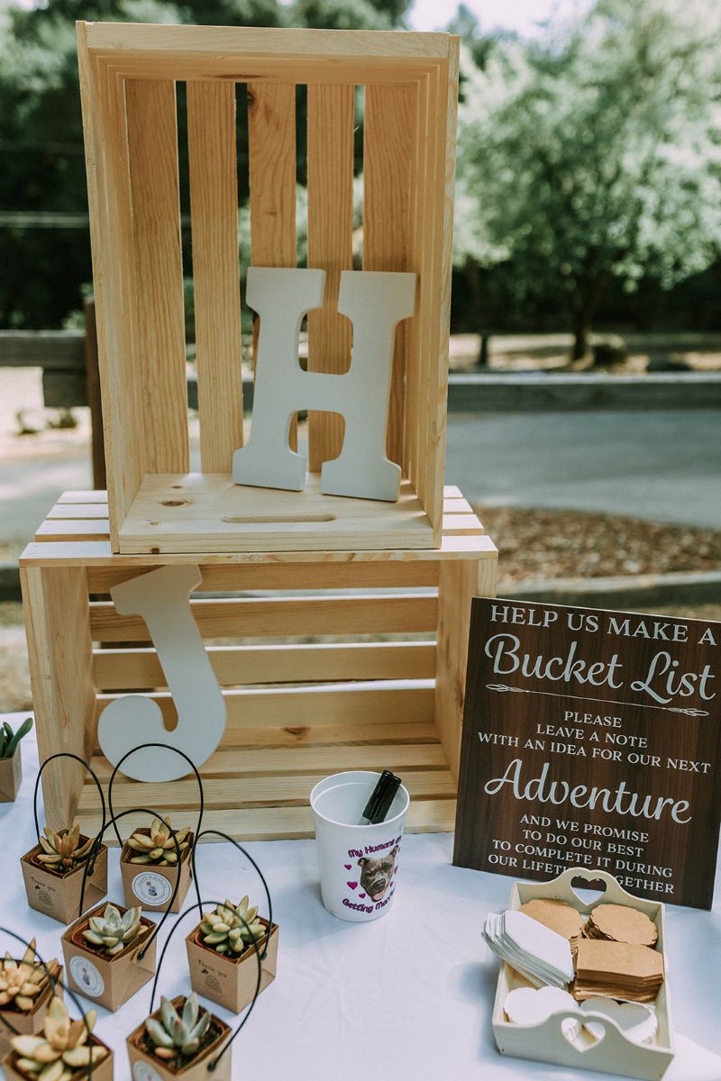 wedding decor including plants, boxes with letters, and a cup with dog treats