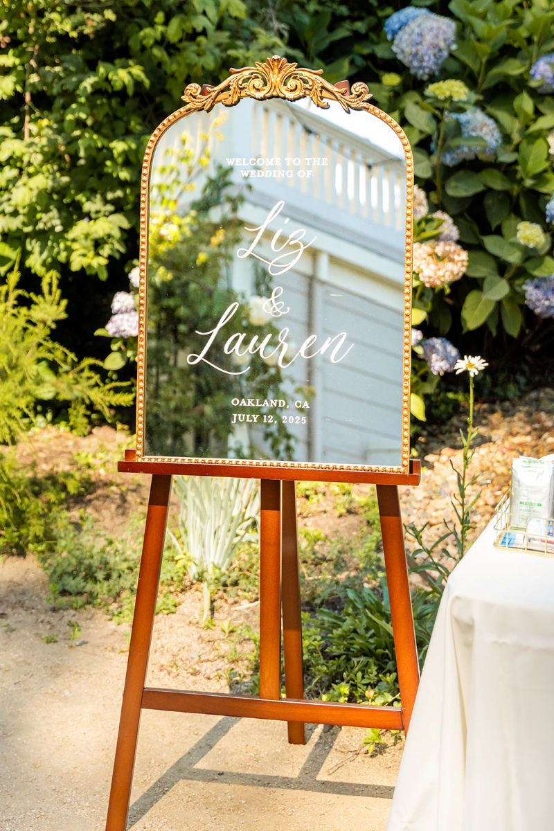 a mirror on display with names on it as part of wedding decor for a wedding at camron stanford house 