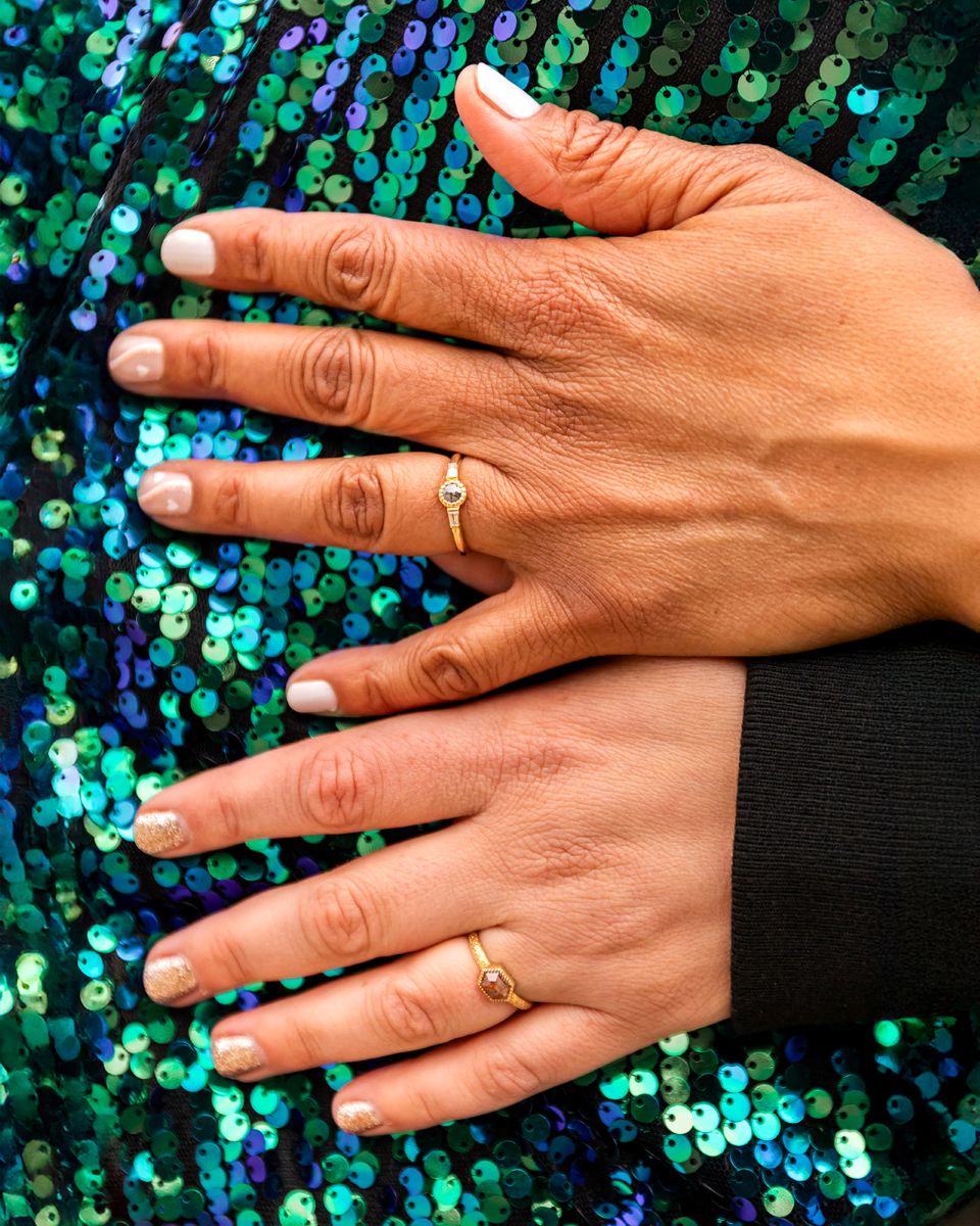 a couple showing off their wedding rings 