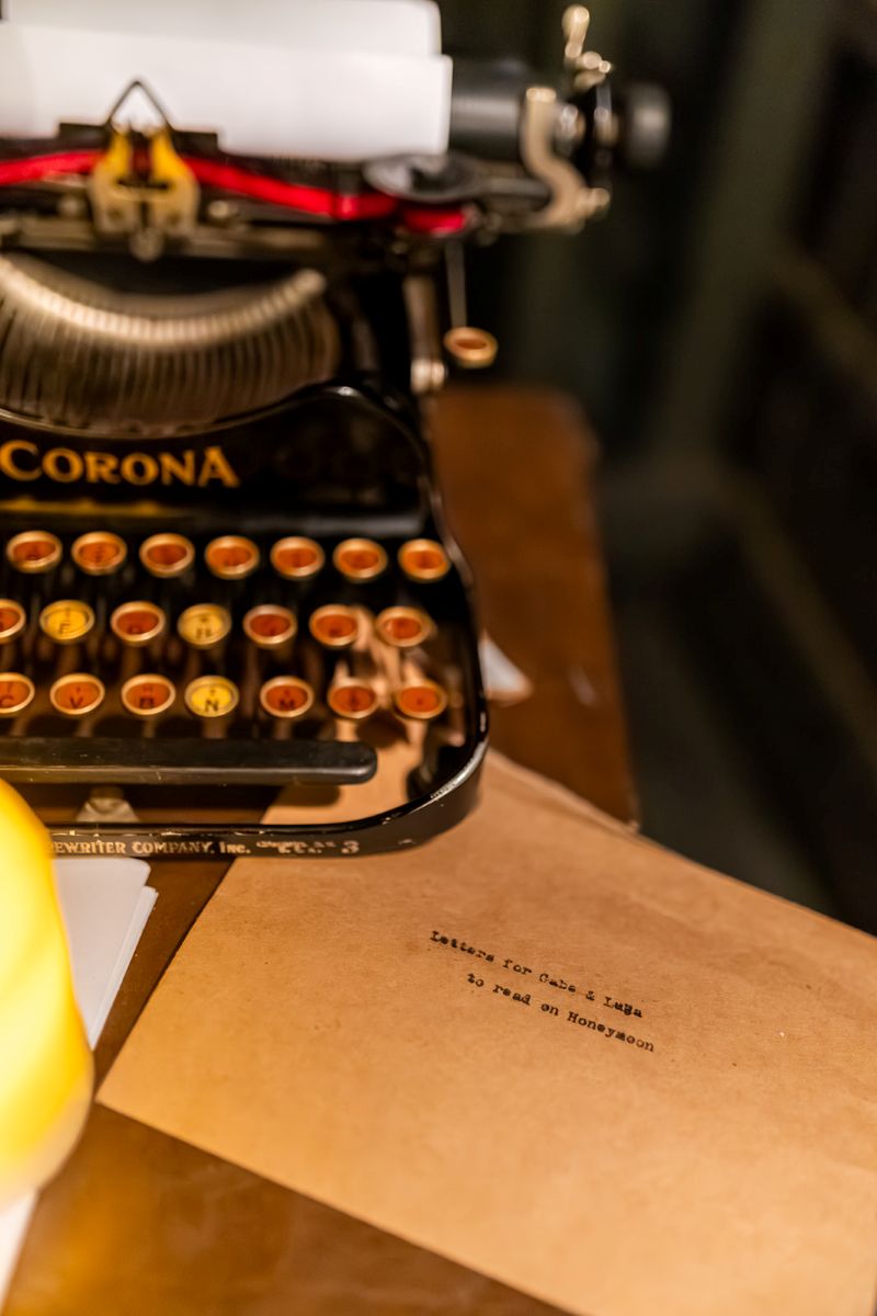 a typewriter resting on a table next to it is a brown envelope 