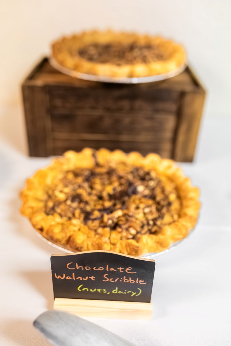 a chocolate walnut pie on top of a white tablecloth 