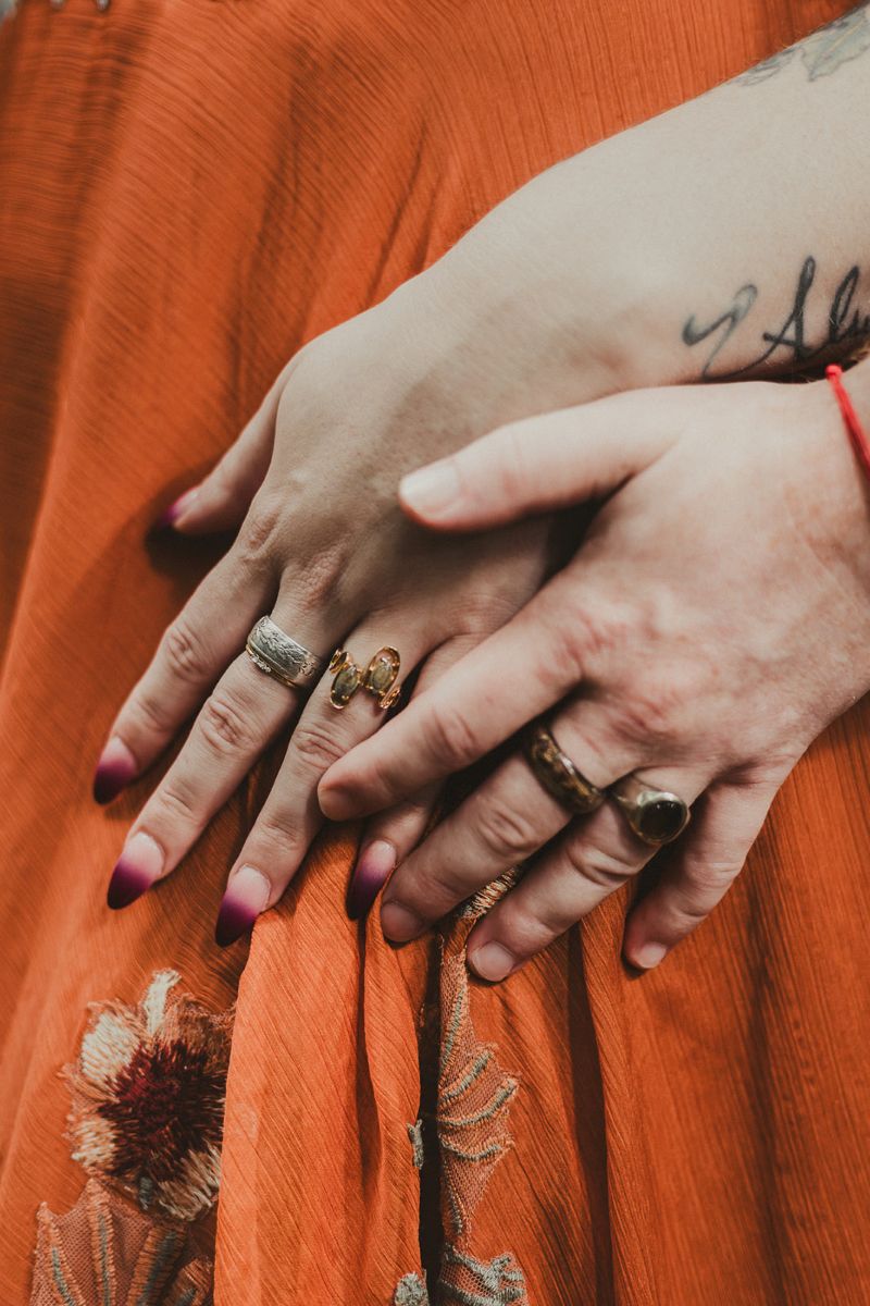 a couple showing off their unique wedding rings 