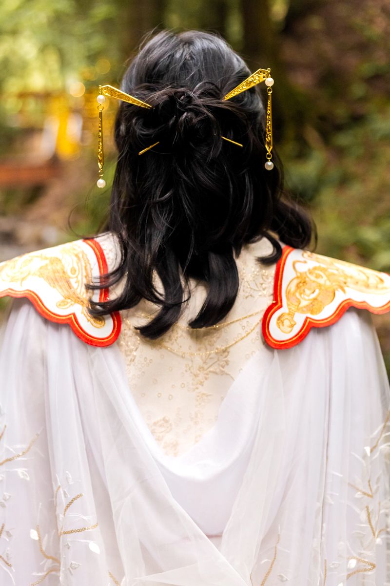 a woman wearing a chinese inspired outfit 