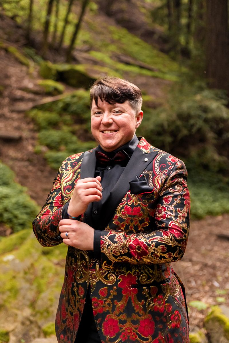 a person wearing a colorful suit jacket smiling 