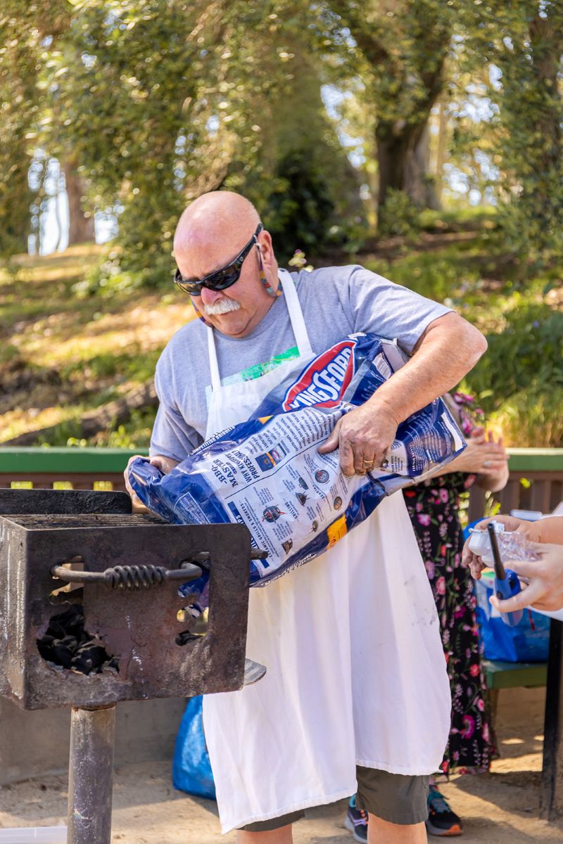 a man preparing a bbq for a wedding reception