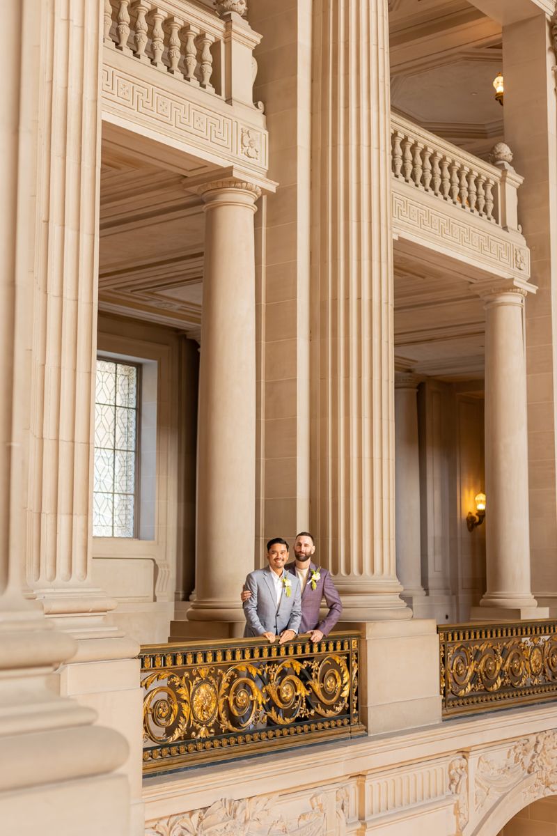 a couple taking wedding portraits together in san francisco city hall