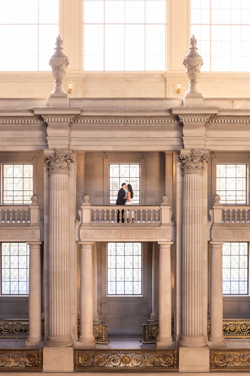 a couple taking wedding portraits in san francisco city hall