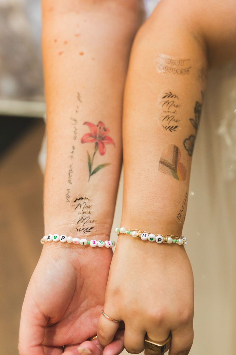 two women showing off their matching friendship bracelets
