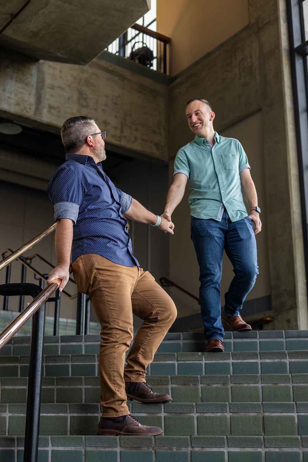 a queer couple taking engagement photos inside of the monterey bay aquarium 